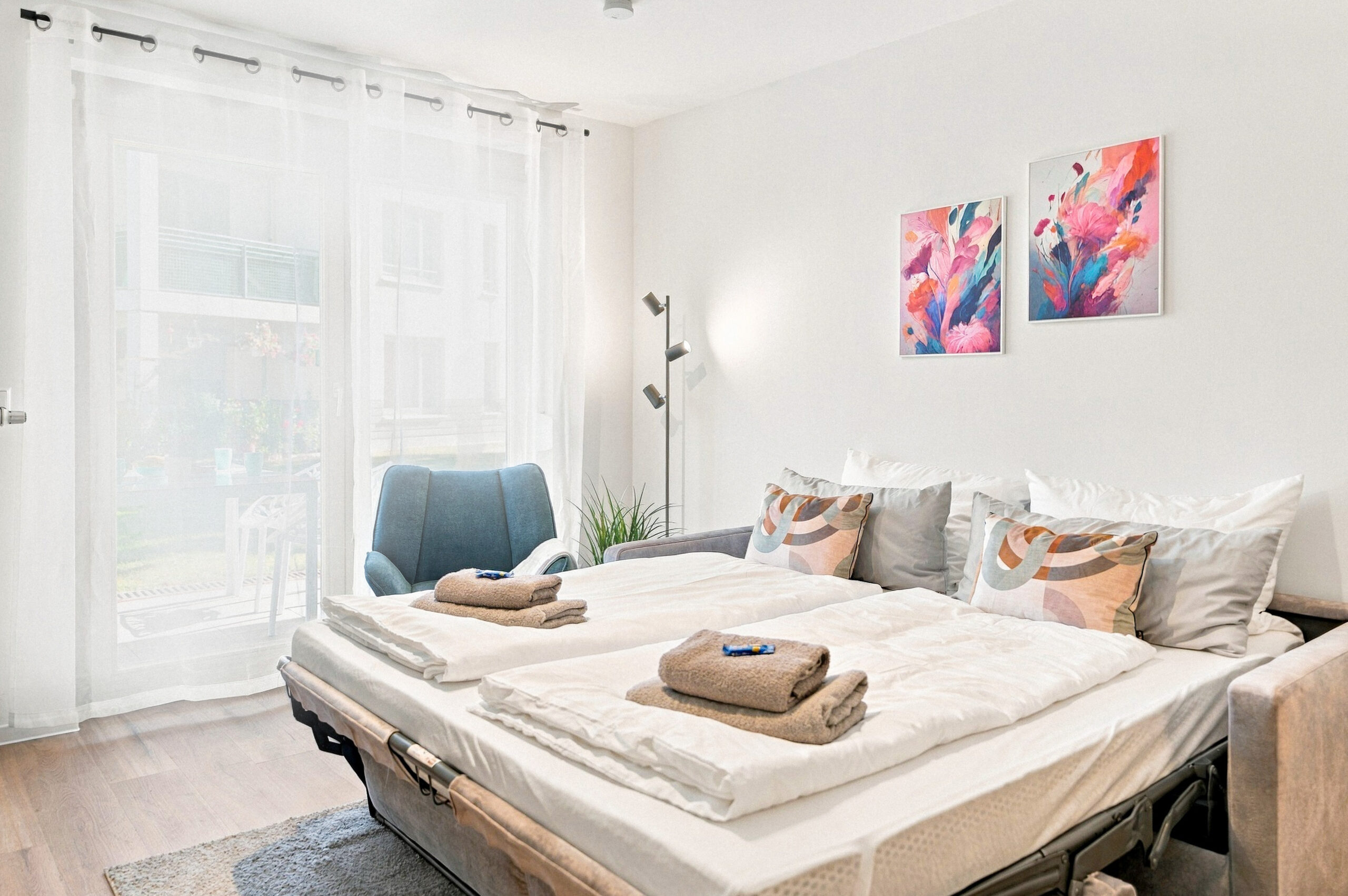 Bedroom with sofa bed and colorful wall art