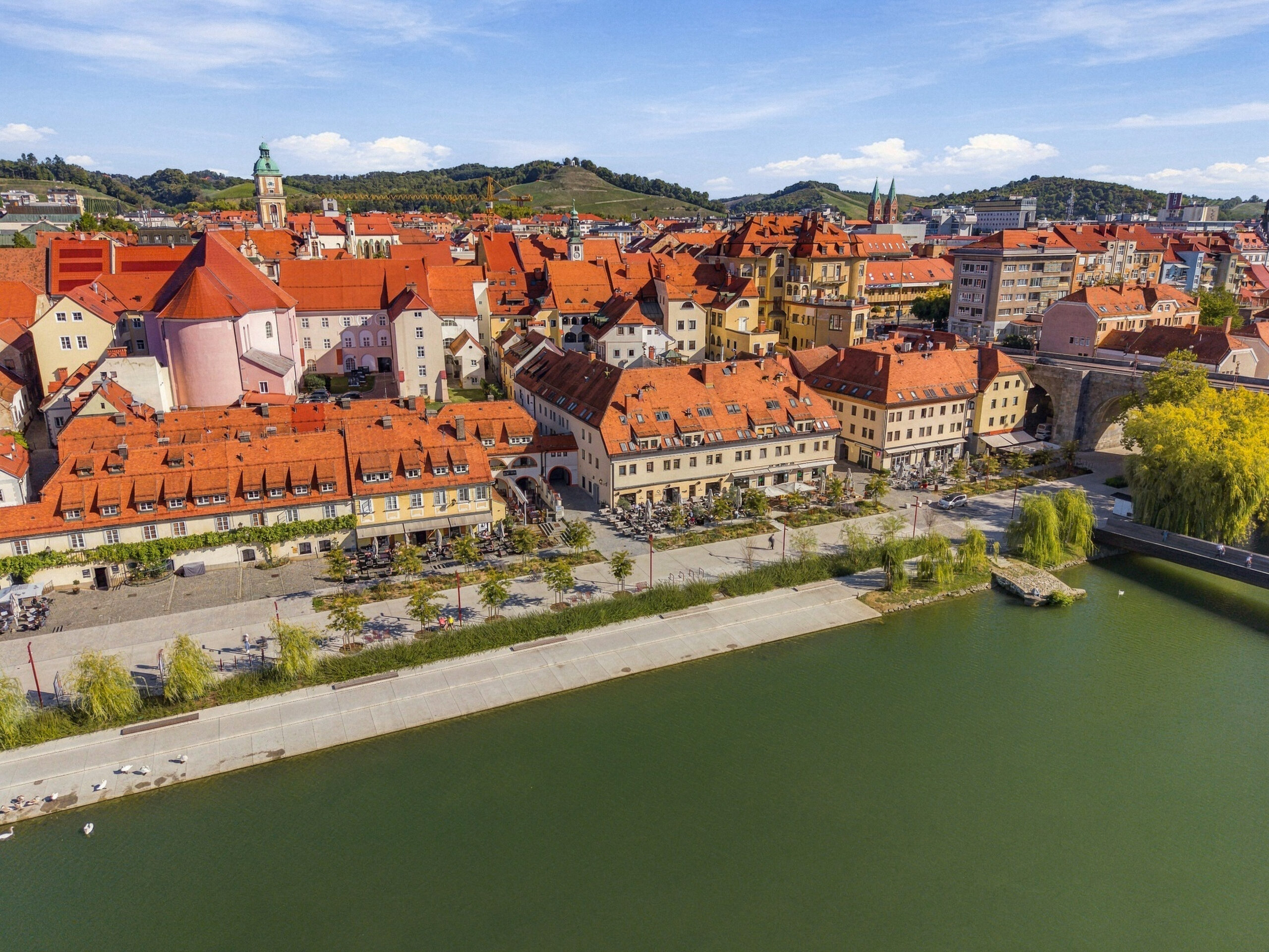 Aerial view of riverside town with red rooftops