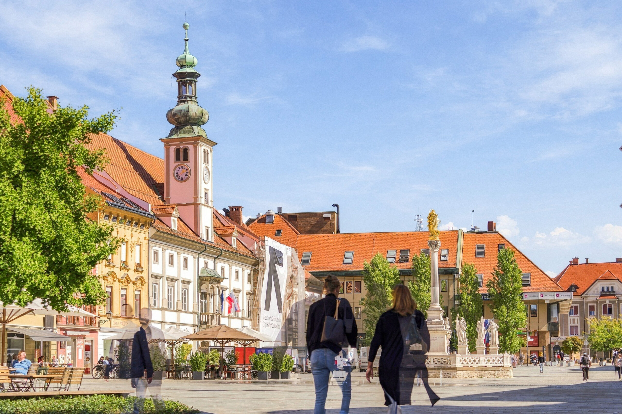 Town square with church tower and statue