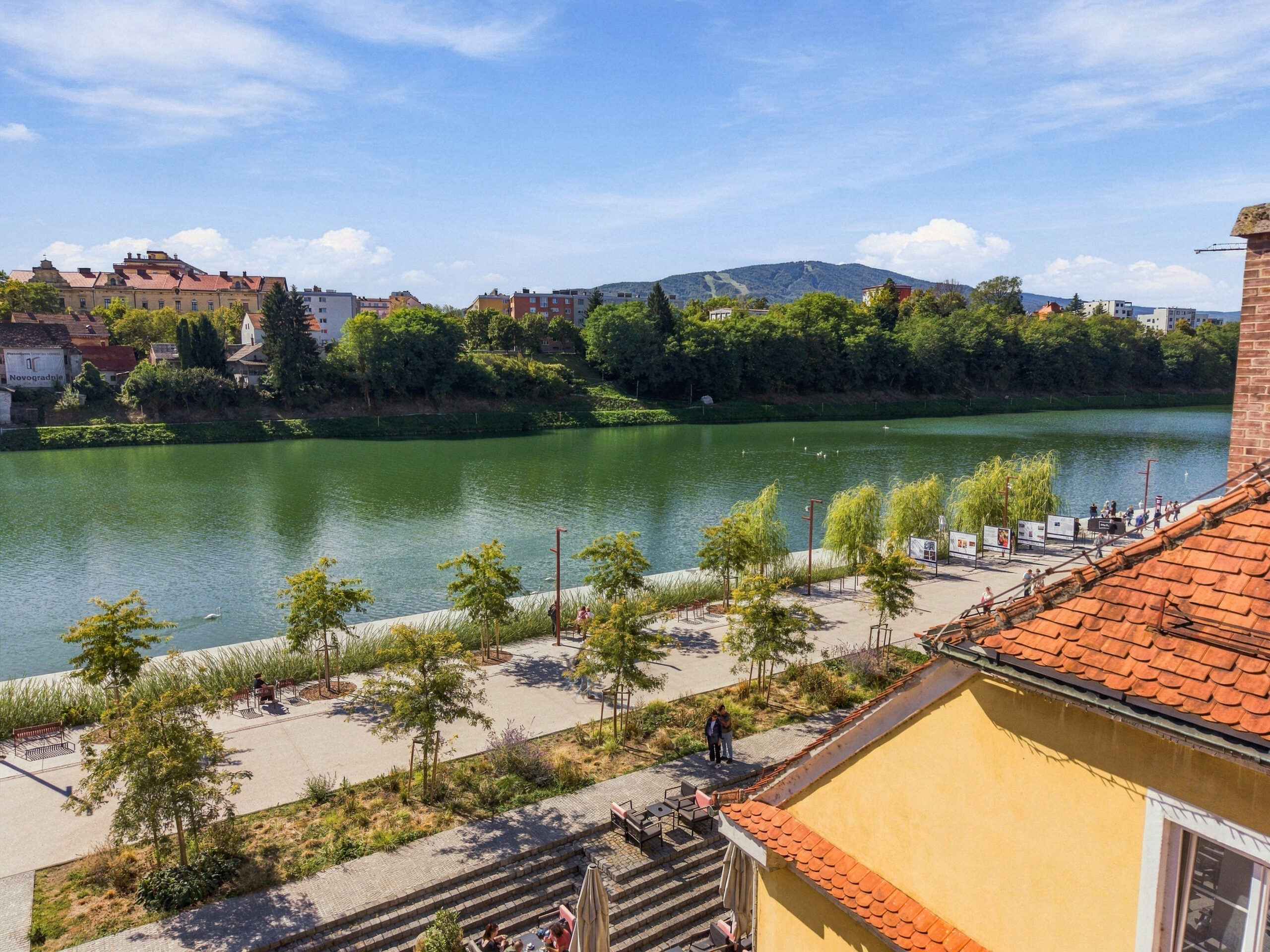 Balcony view over river with trees and hills