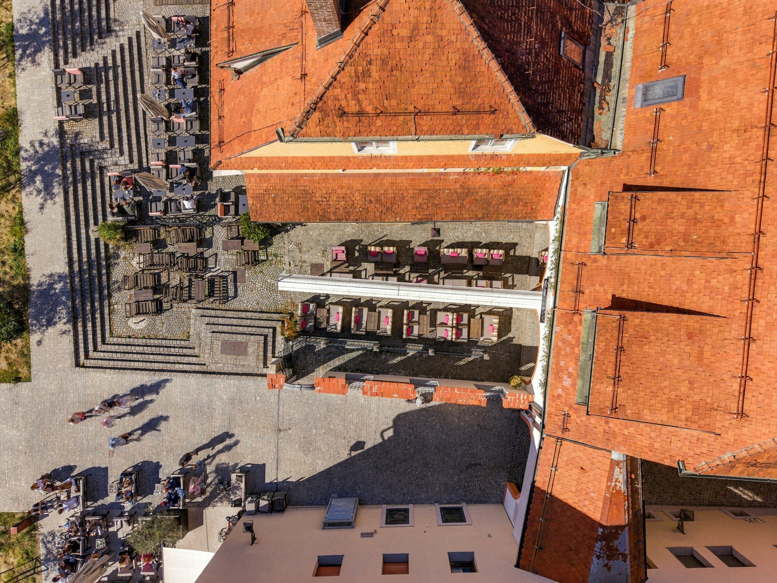 Aerial view of building corner with square and stalls