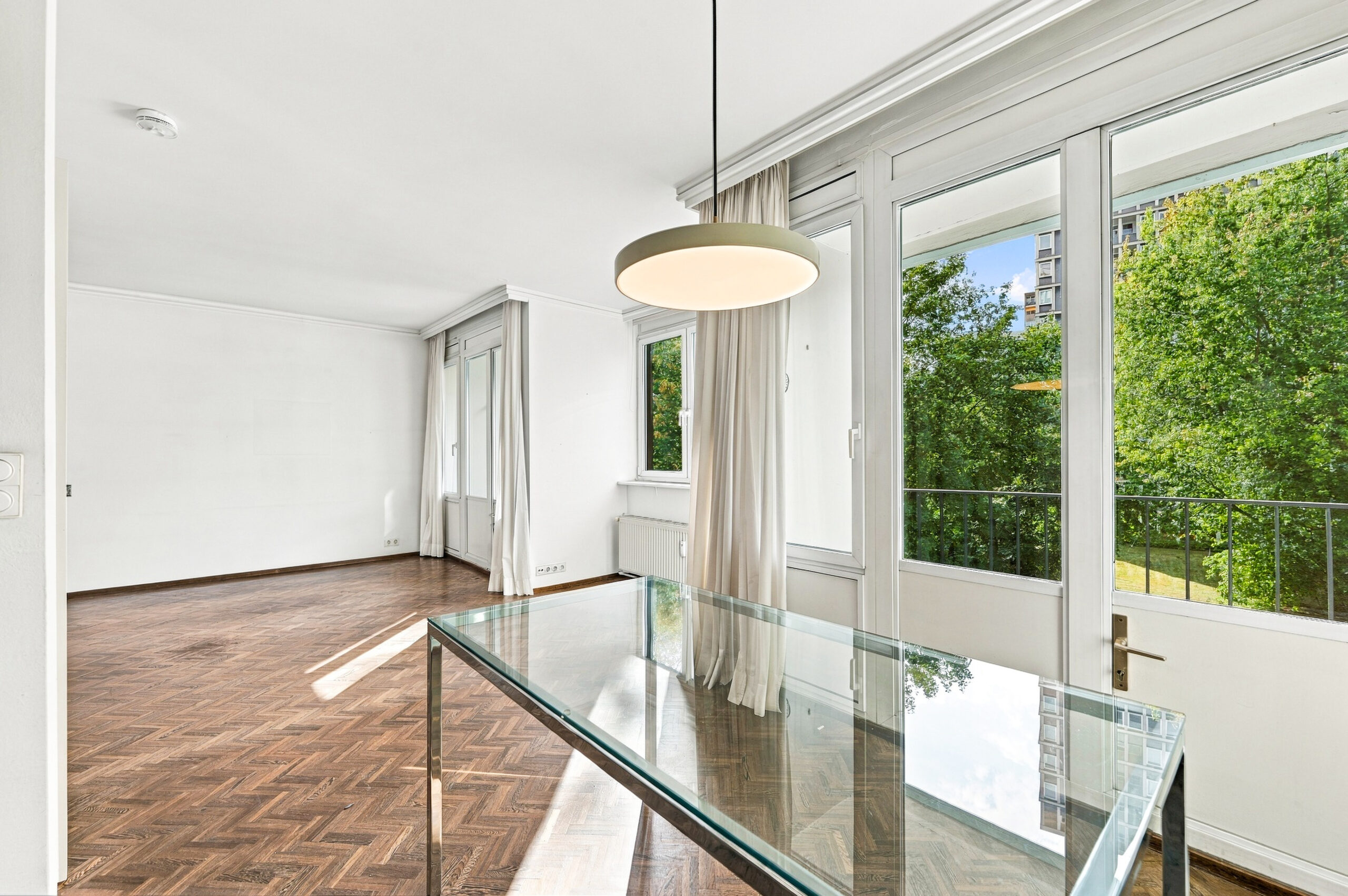 Dining area with glass table and balcony door