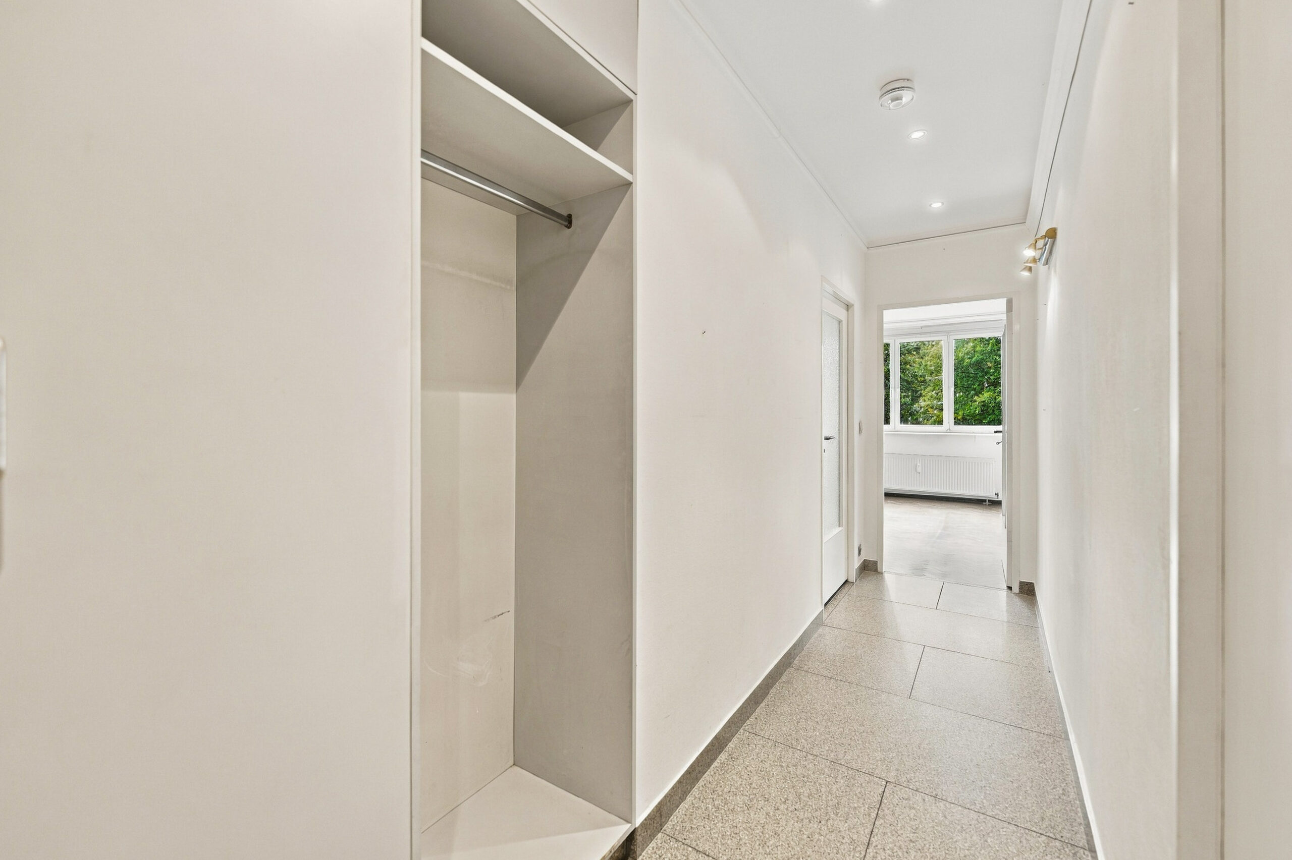 Entrance hallway with white storage and tiled floor