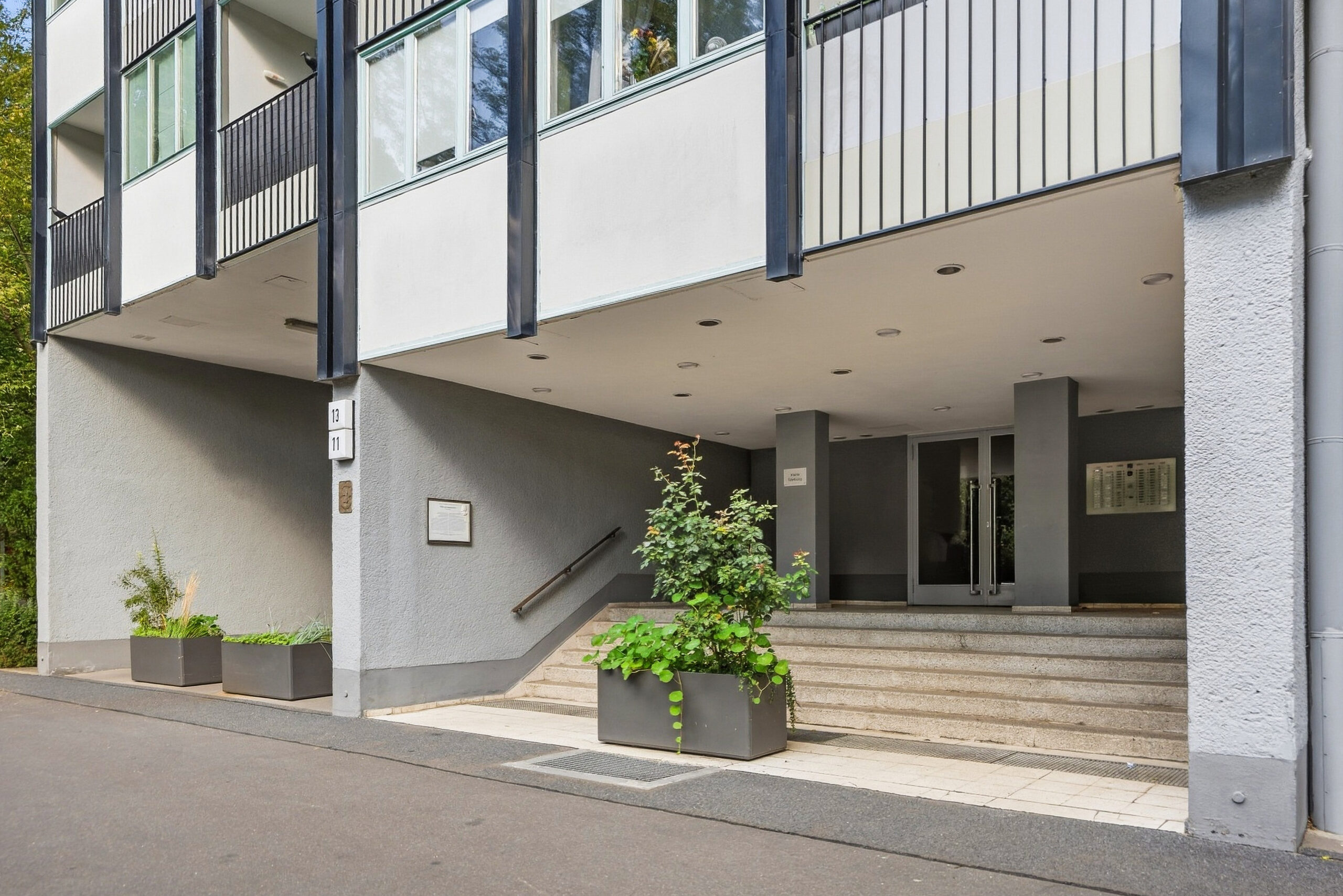 Entrance of building with stairs and planters