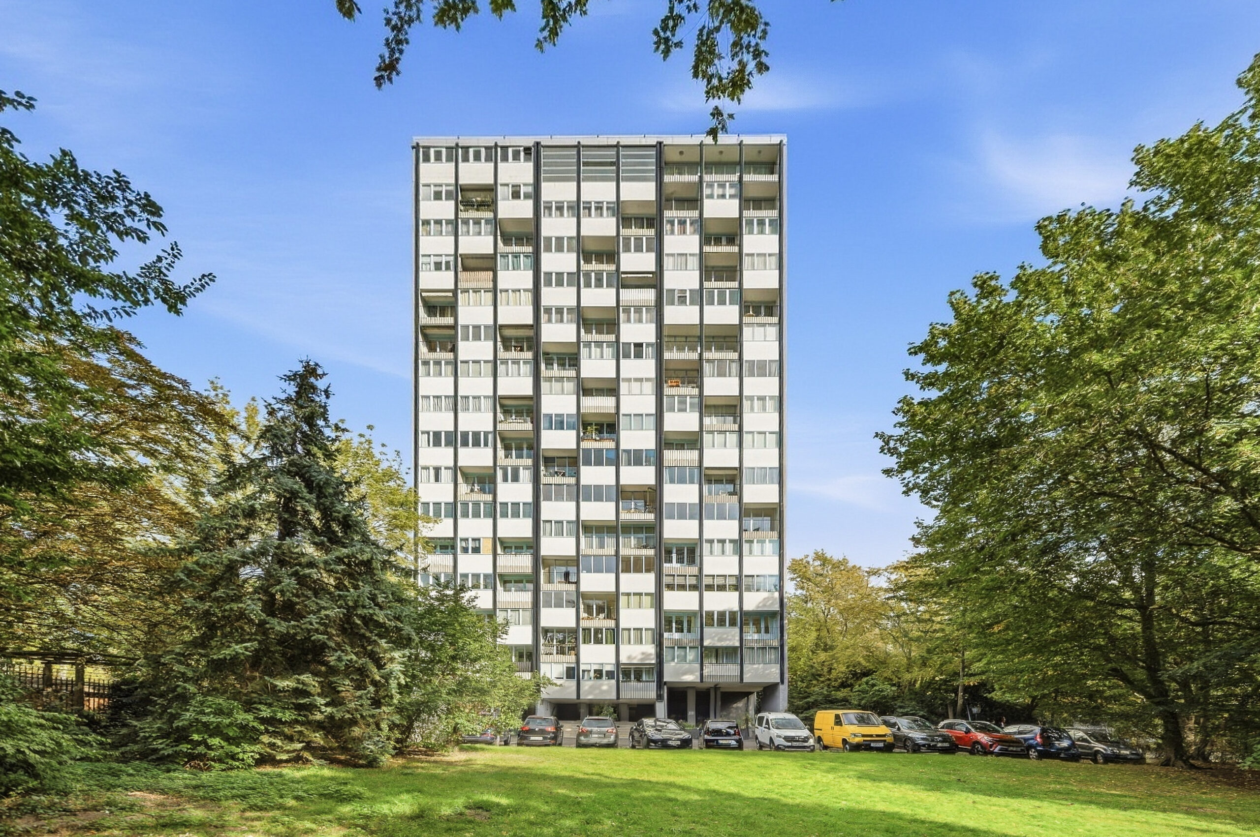High-rise apartment building surrounded by trees