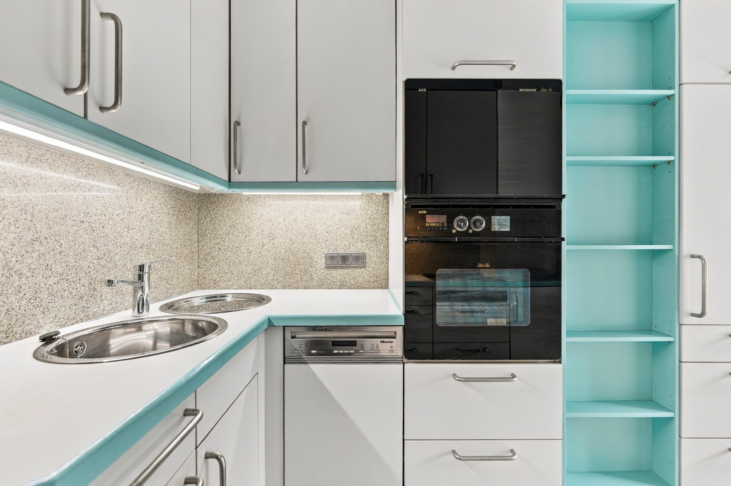 Kitchen counter with sink and built-in appliances