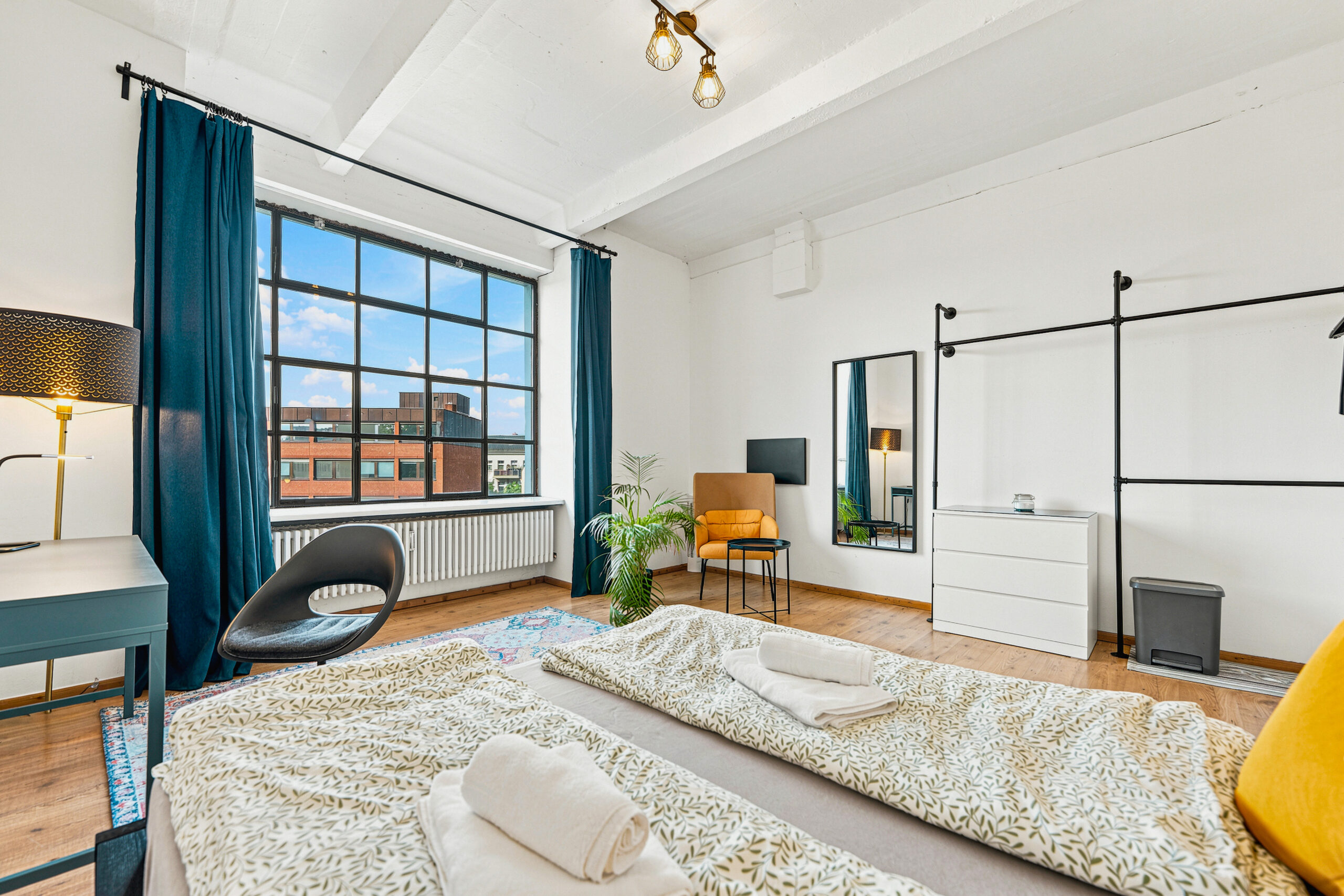 Spacious bedroom with canopy bed and large window