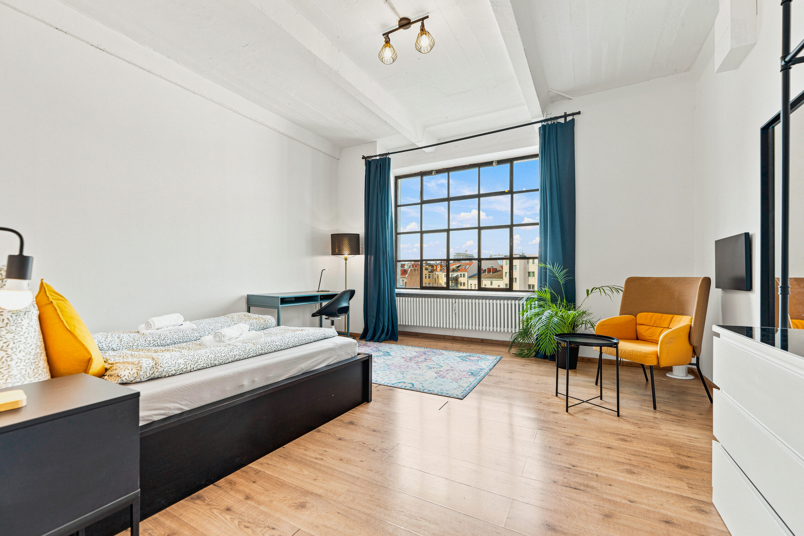 Bedroom with dark bed frame and window seating area