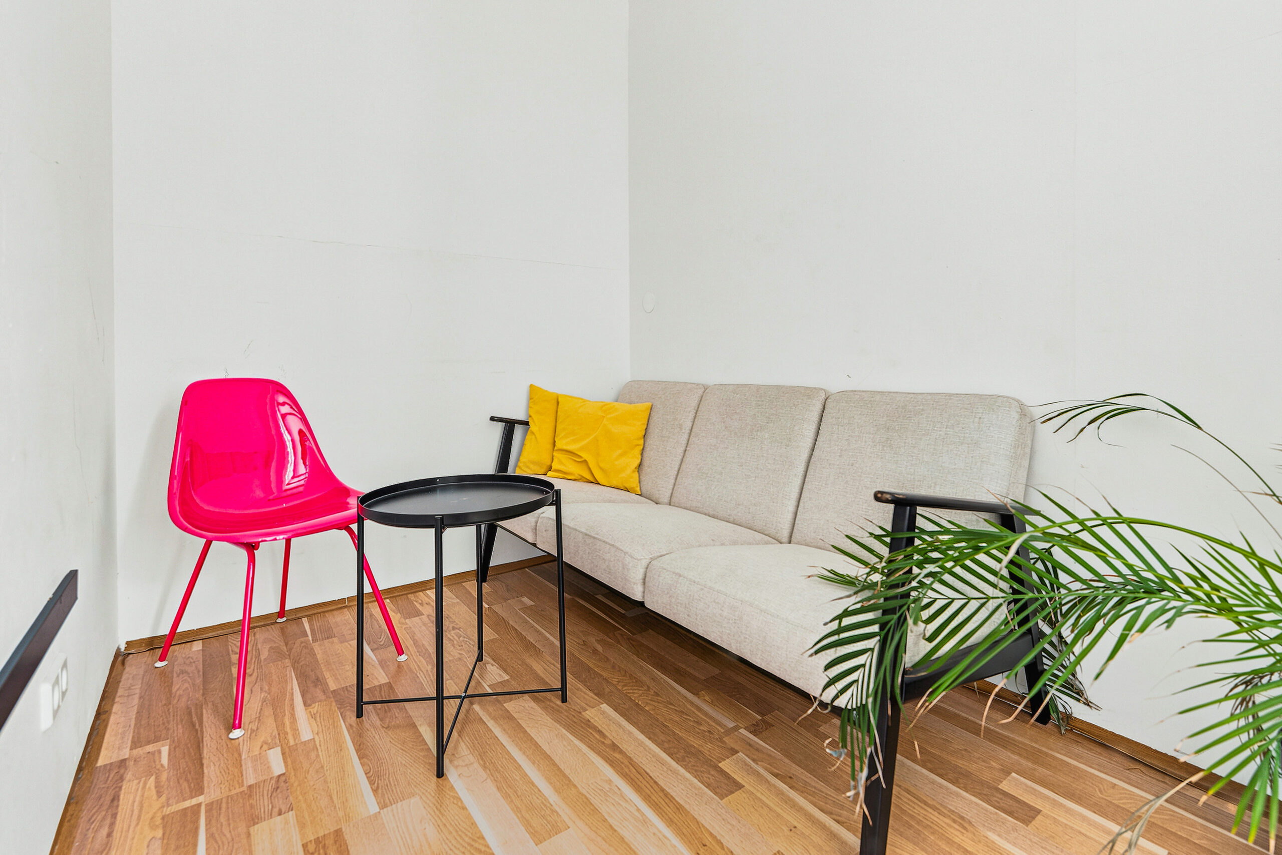 Cosy living room with grey sofa and colourful accent chairs
