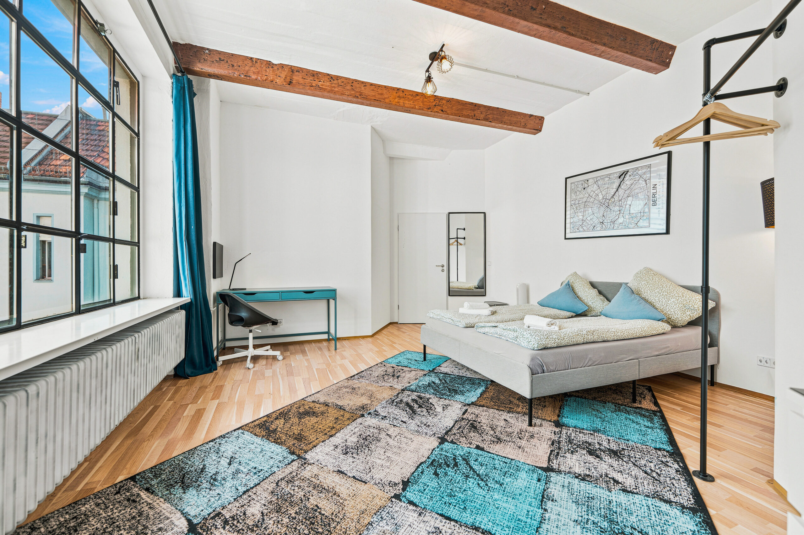 Spacious bedroom with exposed beams and large window