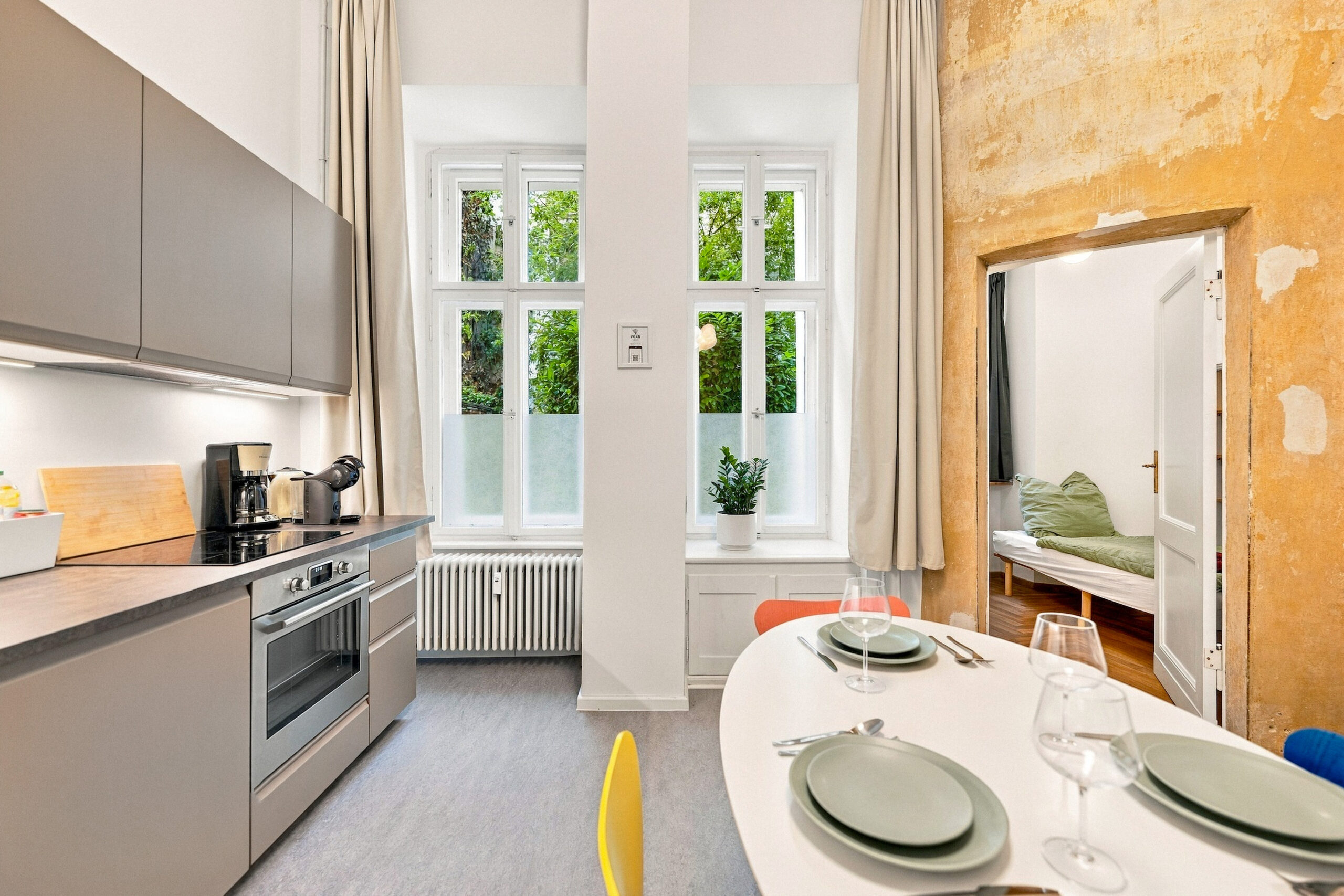 Kitchen area with dining table and colorful chairs