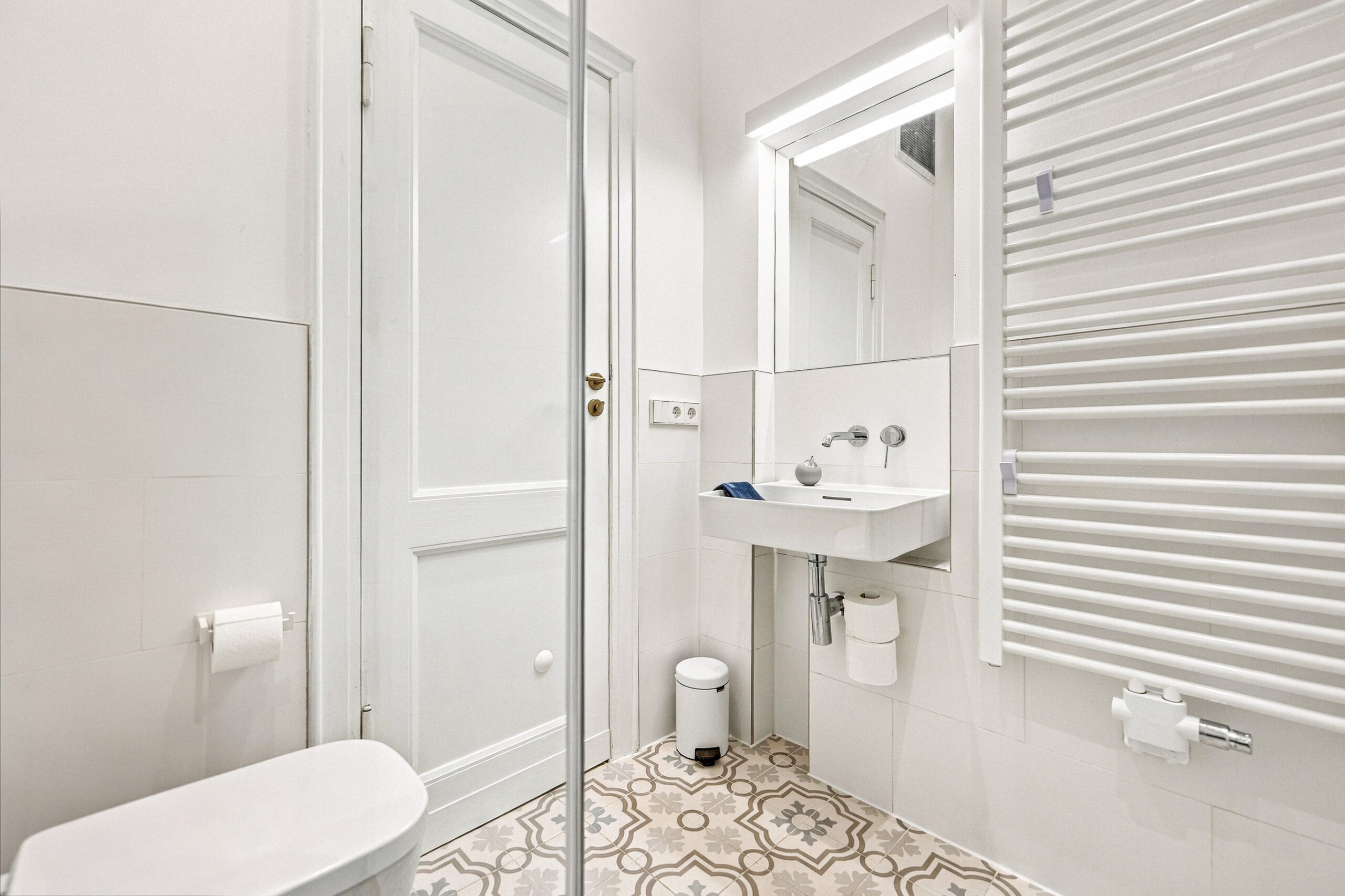 Small bathroom with shower, sink and toilet